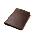 Medium Moleskin Cover in Dark Coffee Brown, closed and angled showing stitched edges and debossed logo