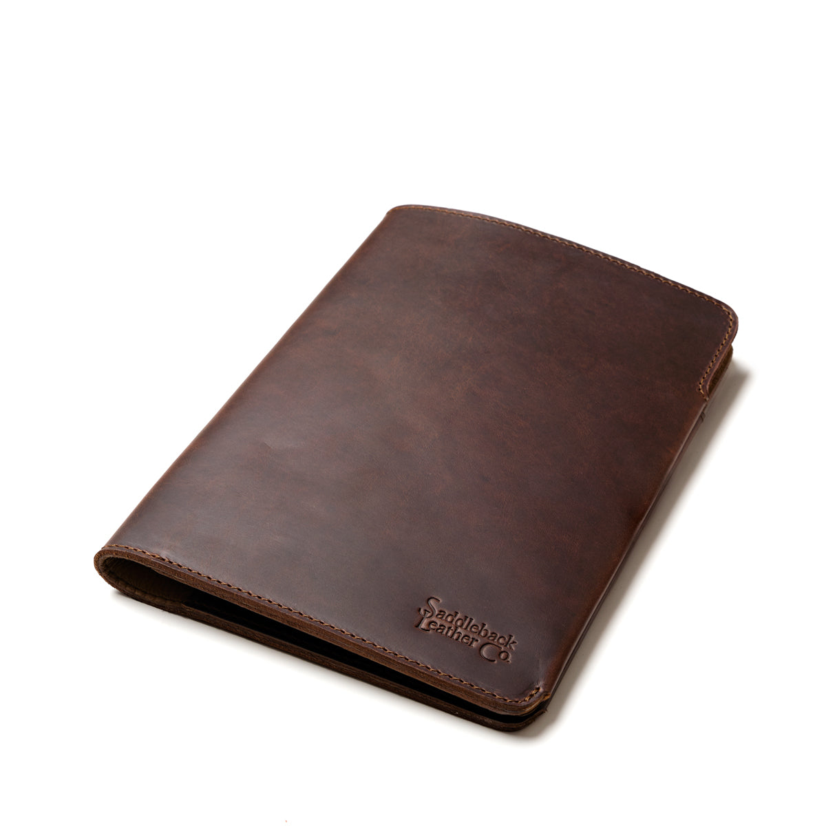 Medium Moleskin Cover in Dark Coffee Brown, closed and angled showing stitched edges and debossed logo