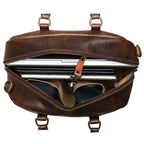 Professional Leather Satchel in Dark Coffee Brown, top view unzipped with a laptop, notebook and sunglasses inside