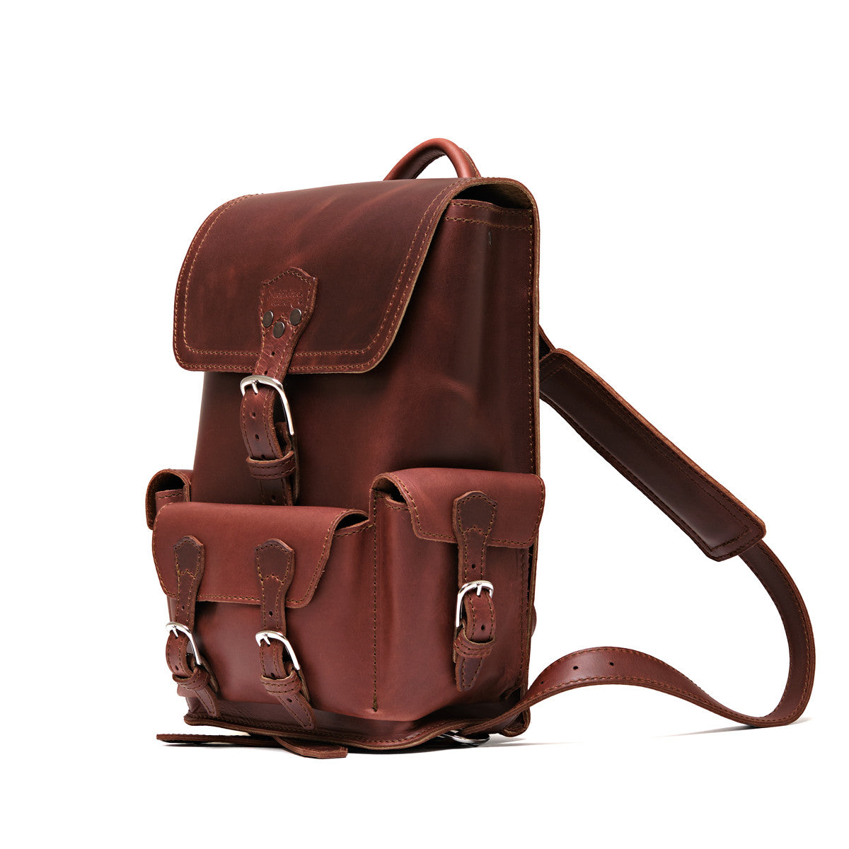 Small Front Pocket Backpack in Chestnut, angled side view with the buckled front and side pockets and a shoulder strap