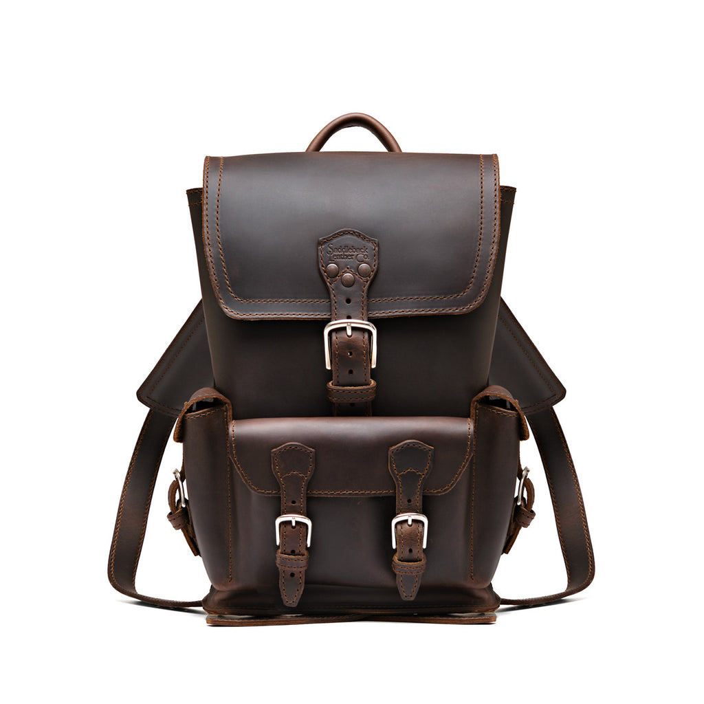 Small Front Pocket Backpack in Dark Coffee Brown, front view showing the buckled flap, front pocket and shoulder straps