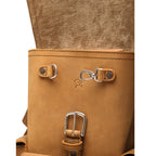 Small Front Pocket Backpack in Tobacco, close-up of the front with D-rings, a key clip, a buckle and a small embossed logo