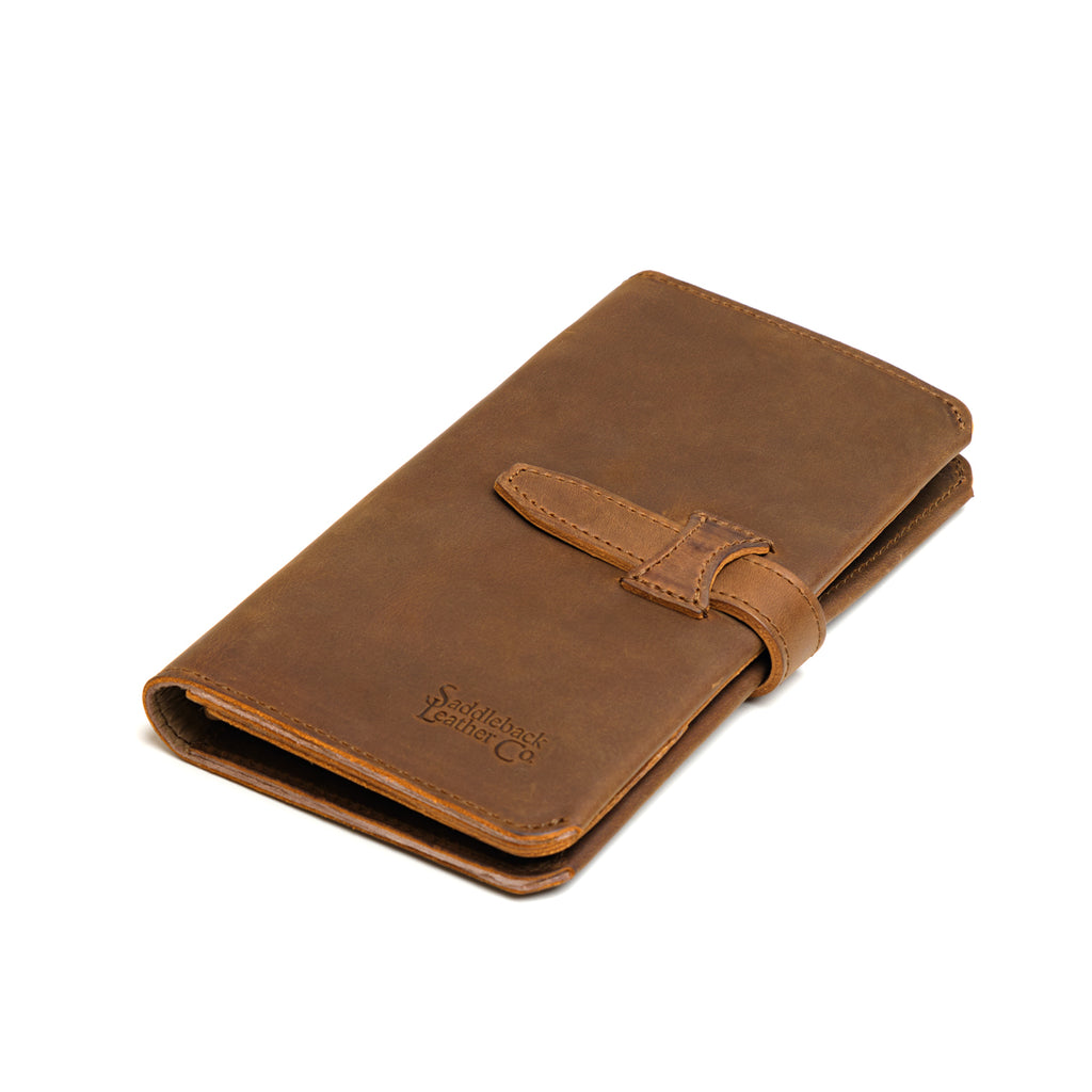 New Big Wallet in Tobacco, angled front view lying flat with strap closure