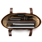 Original Tote in Dark Coffee Brown, top-down view packed with a laptop, notebooks, folders and keys