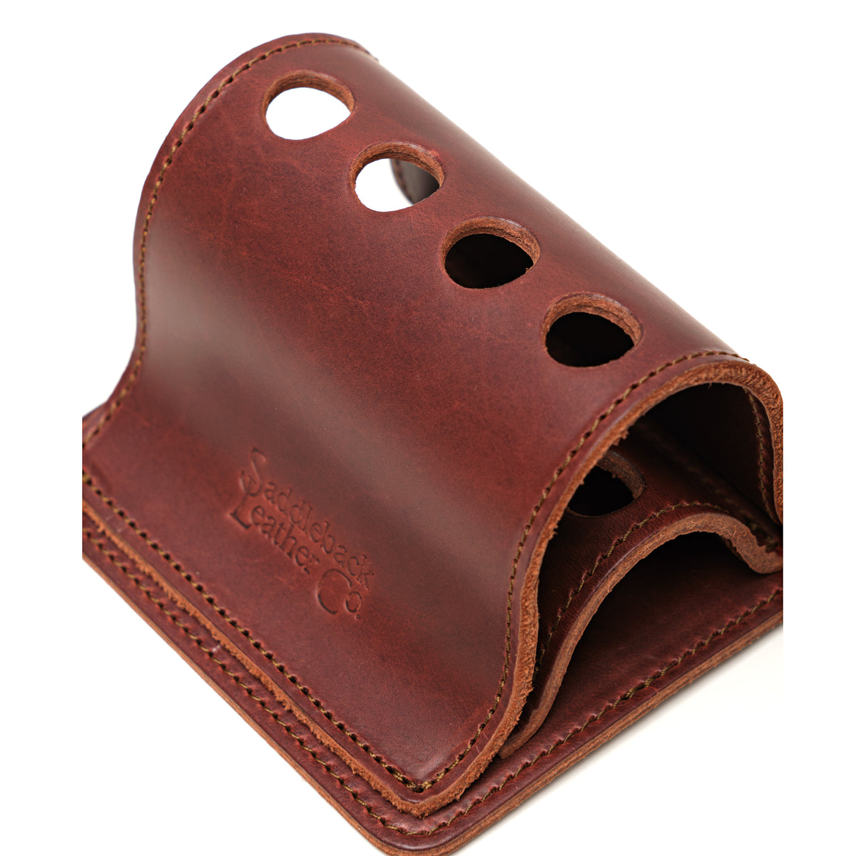 Pen Holder Bell Curve in Chestnut leather, close-up angled view of the four pen holes and embossed logo