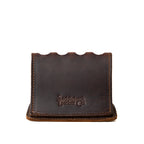 Pen Holder Bell Curve in Dark Coffee Brown leather, empty front view showing the scalloped top and embossed Saddleback Leather Co. logo