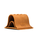 Pen Holder Bell Curve in Tobacco leather, empty angled view showing the layered bell curve shape and embossed logo