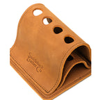 Pen Holder Bell Curve in Tobacco leather, close-up angled view of the four pen holes and embossed logo