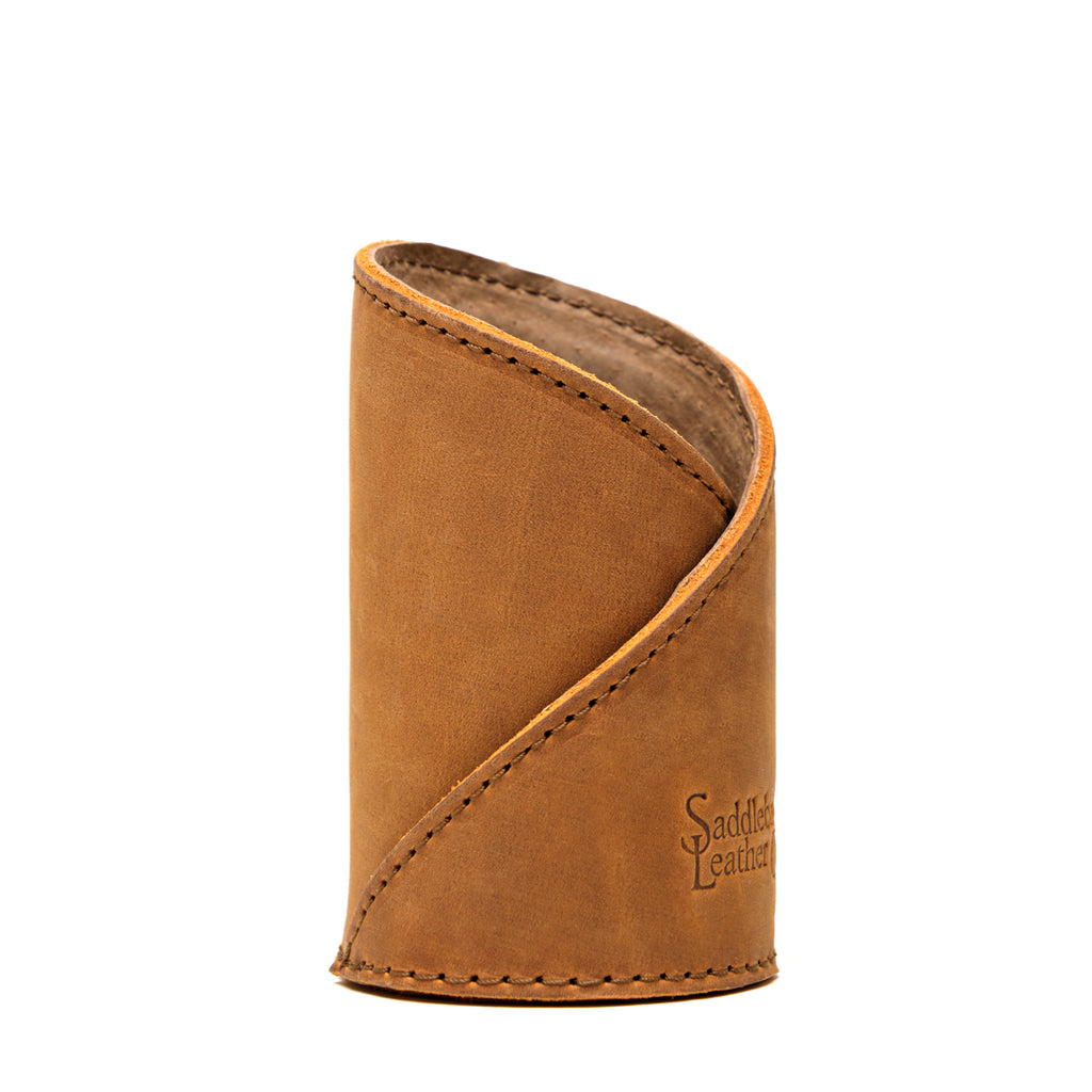 Pen Cup in Tobacco leather, front view of the empty cup with diagonal stitched wrap and embossed logo