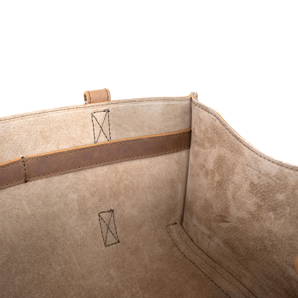 Range and Tool Tote interior close-up showing suede-side leather, X-box stitching and an inner tool strap
