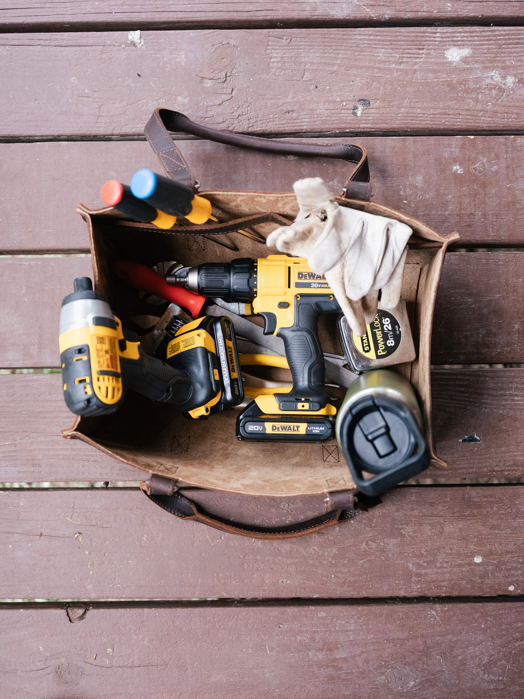 Range and Tool Tote open on a wooden deck, filled with cordless power tools, screwdrivers and work gloves