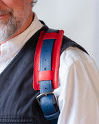 Saddleback Club Membership Paul Revere Leather Messenger Bag Backpack in Red, White and Blue, red shoulder pad on blue strap worn