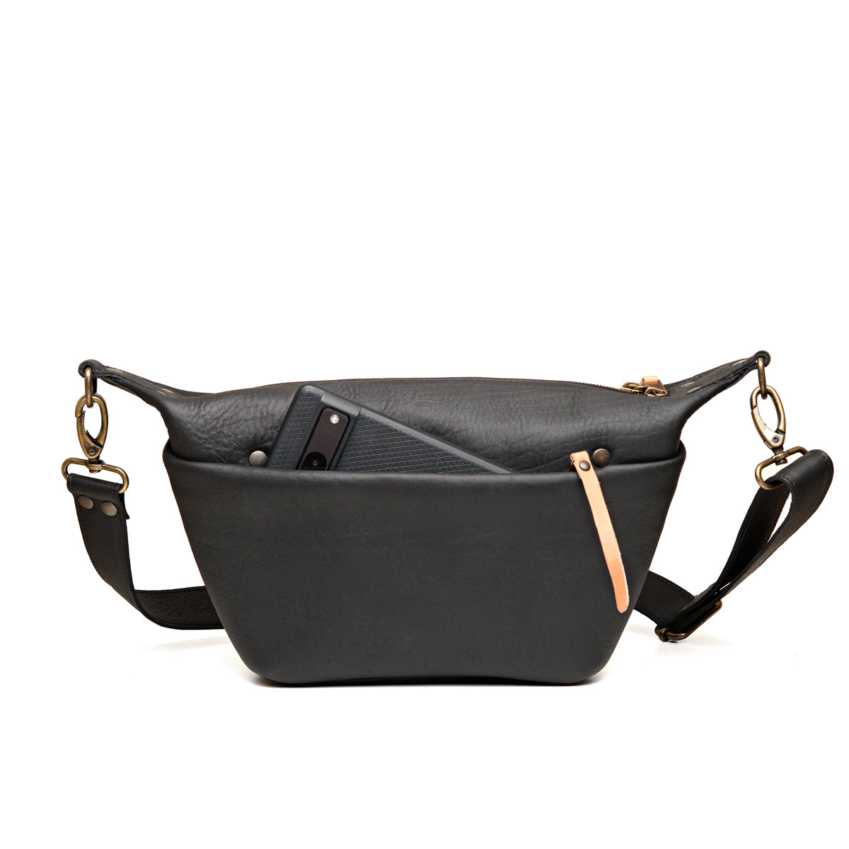 London Sling Small in Black, front view with a phone tucked in the snap pocket