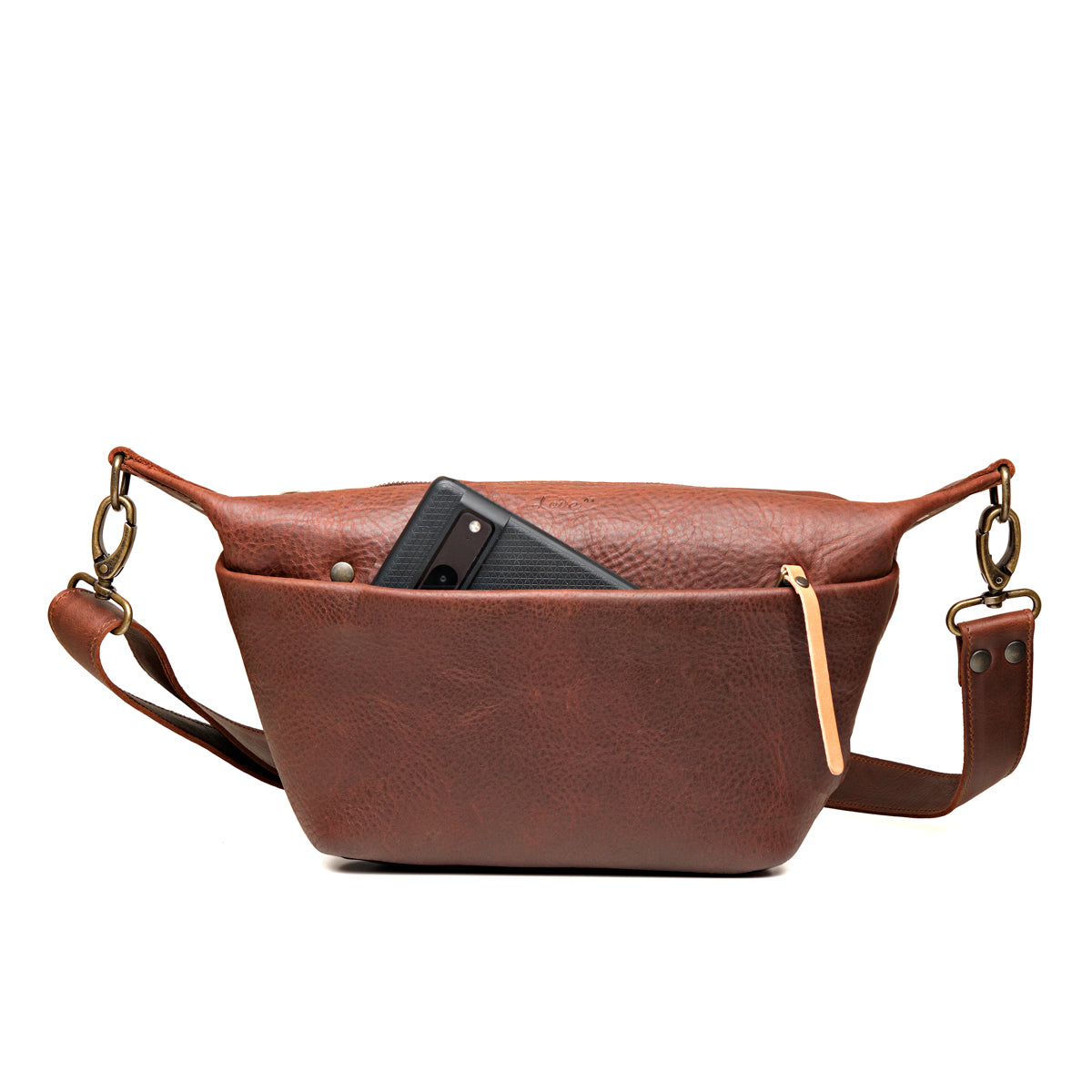 London Sling Small in Chestnut, front view with a phone tucked in the snap pocket
