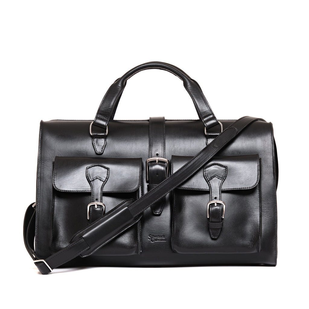Wesley Deep Pocket Duffle in Raven Black, front view with two buckled pockets and shoulder strap