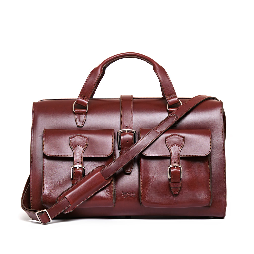Wesley Deep Pocket Duffle in Oxblood, front view with two buckled pockets and shoulder strap