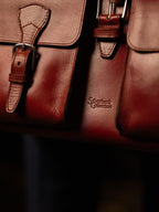 Blackstone Barrister Briefcase in Oxblood, close-up of buckled pocket straps and debossed Silverback Collection logo