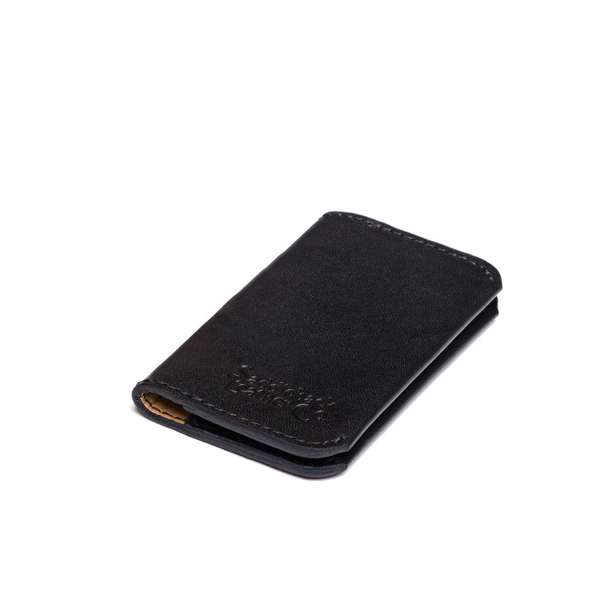 Slim Business Card Holder in Black, closed angled view with embossed logo