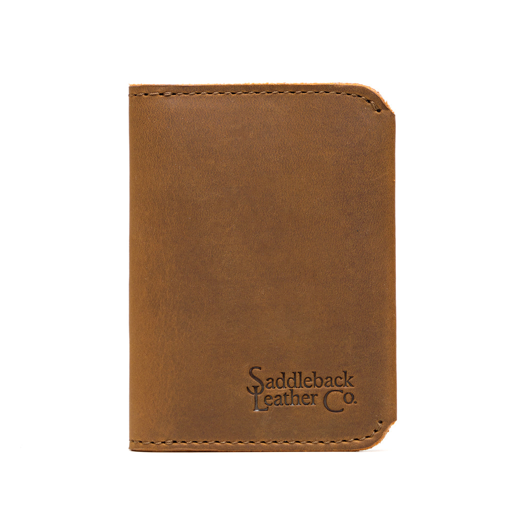 New Slim Leather Bifold Wallet in Tobacco, closed front view with embossed logo and rounded corners