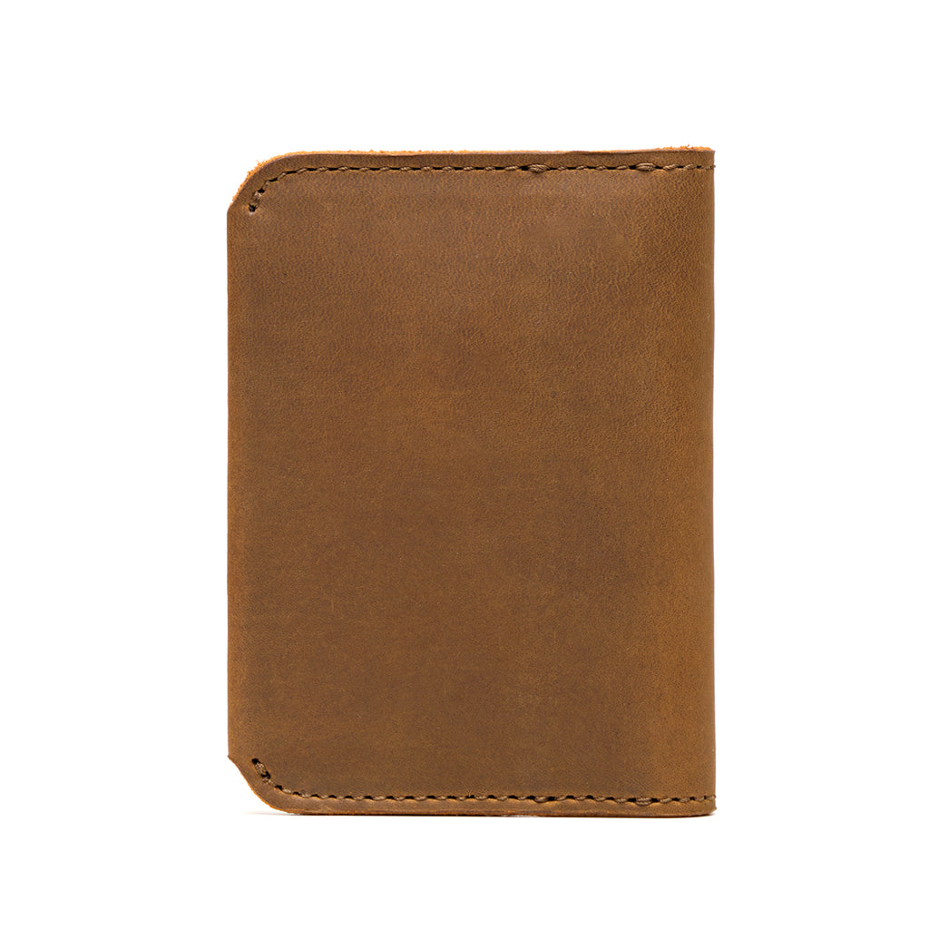 New Slim Leather Bifold Wallet in Tobacco, closed back view with rounded corners and stitched edges