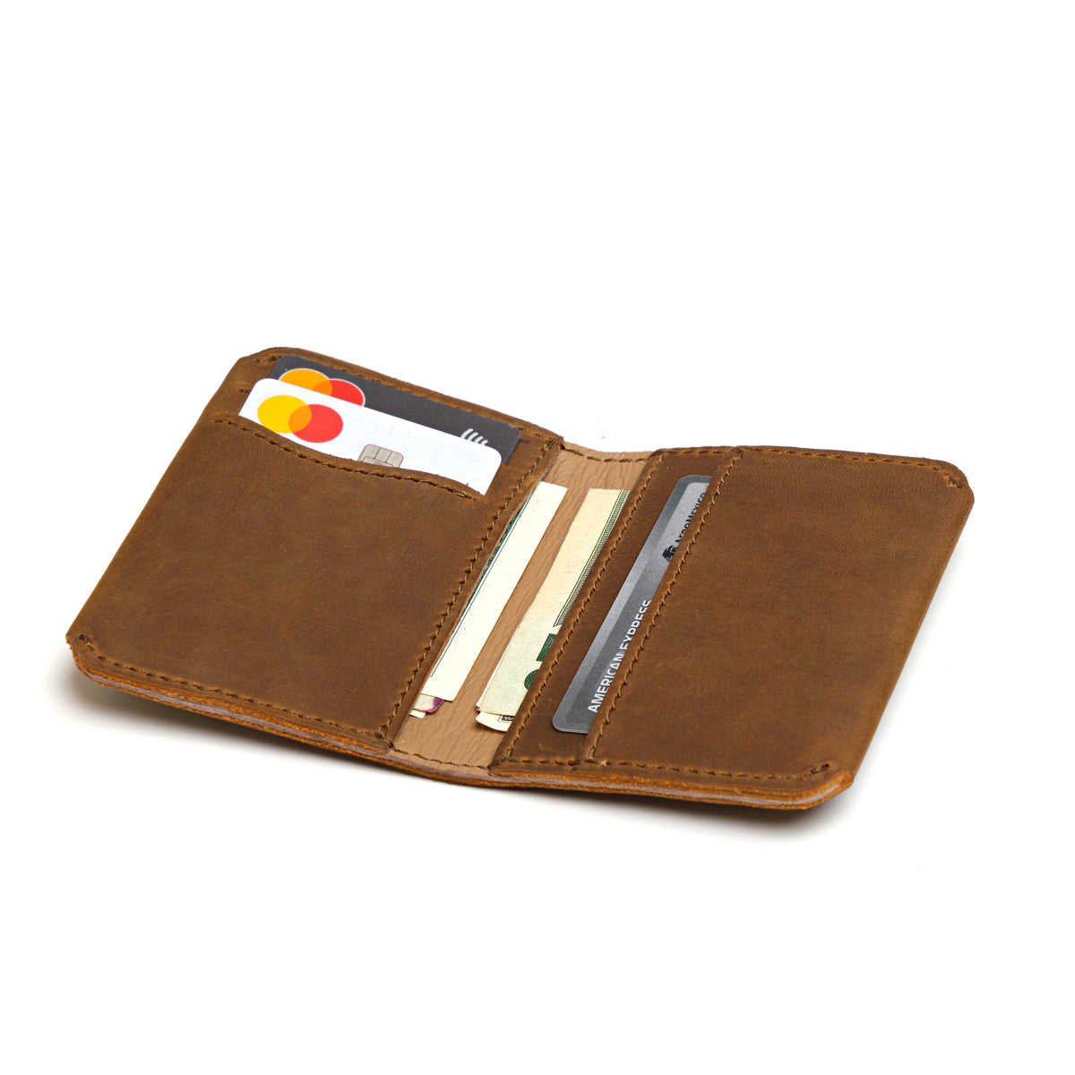 New Slim Leather Bifold Wallet in Tobacco opened flat to show cards and cash in the slim pockets
