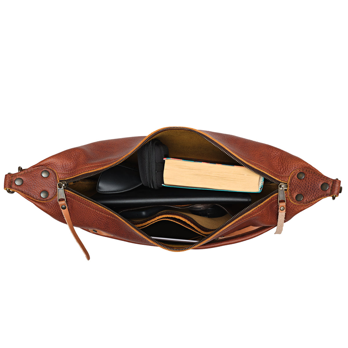 London Sling Large in Chestnut, top view unzipped with a book, tablet and sunglasses inside