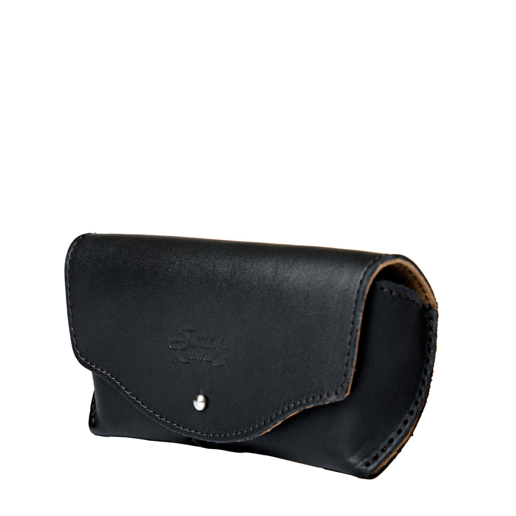 Leather Sunglass Case in Black, closed angled view showing curved flap and snap closure