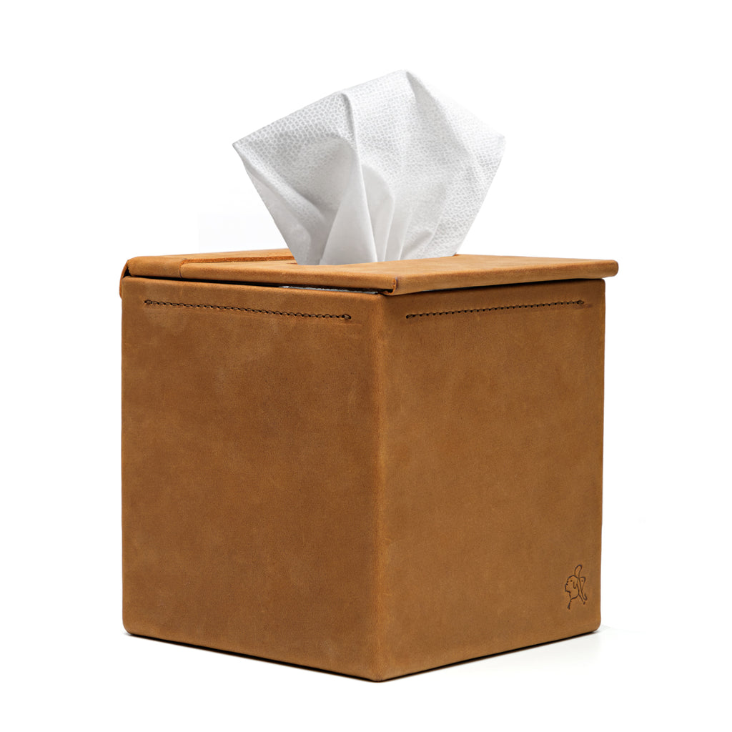 Tissue Box in Tobacco leather, front view with stitched seams and a tissue pulled from the top