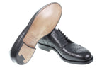 Wingtip Shoes in Raven Black, pair showing the leather sole and side profile on white