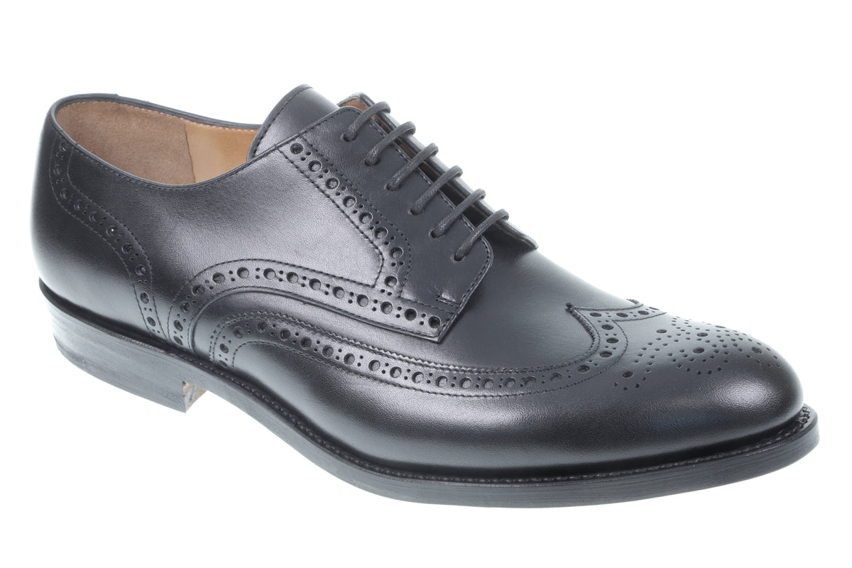 Wingtip Shoes in Raven Black, three-quarter front view of a single shoe on white