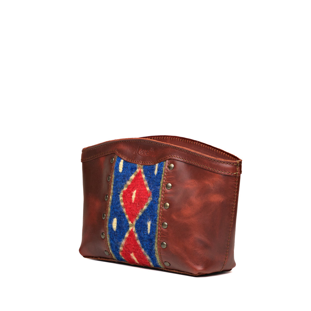 Lanita Leather Clutch in Chestnut, angled front view with woven panel and studs