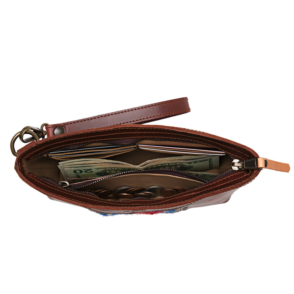 Lanita Leather Clutch in Chestnut, top-down view of unzipped interior holding cash and coins