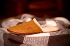 Women's Sheepskin Slipper in Tobacco on a plaid blanket