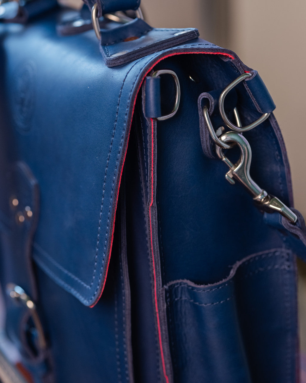 Saddleback Club Membership Paul Revere Leather Messenger Bag Backpack in Red, White and Blue, close-up of side hardware and red edge
