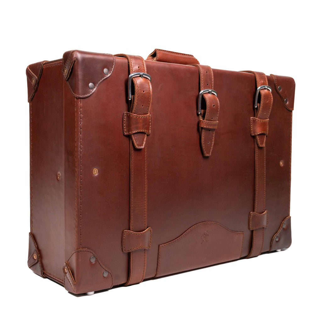 Grandfather Medium Suitcase in Chestnut, angled front view with three buckle straps and top handle