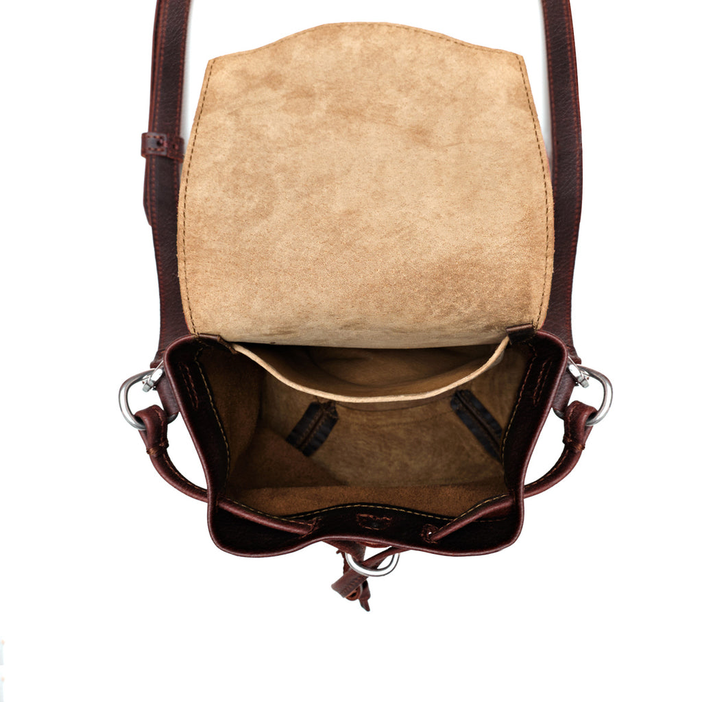 Mini Bucket Bag in Chestnut, top view open and empty showing suede lining and interior pockets