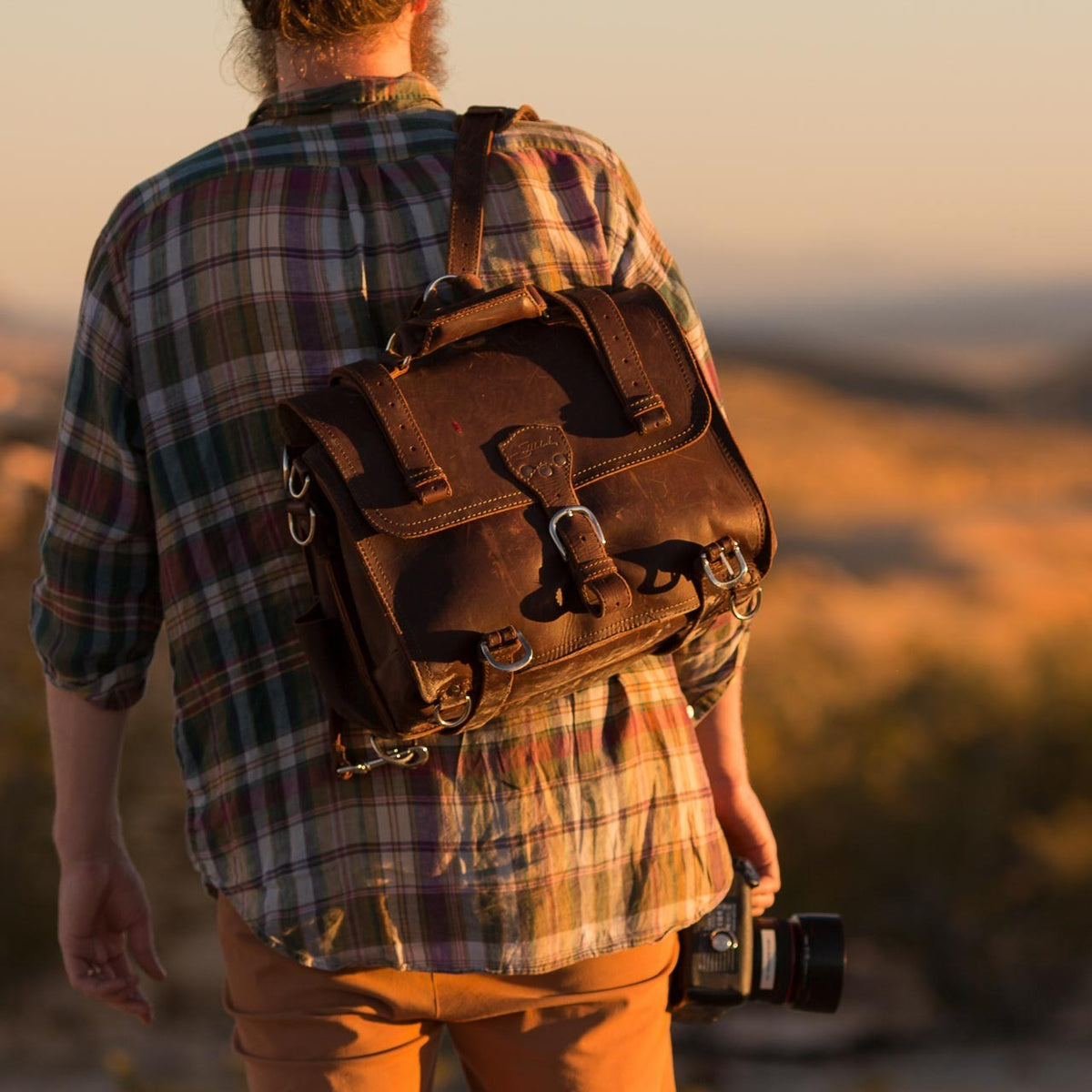 Photographer wearing a brown Classic Leather Briefcase as a convertible backpack at Big Bend National Park