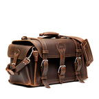 Side Pocket Leather Duffle in Dark Coffee Brown, angled front view with buckle straps, side pocket and shoulder strap