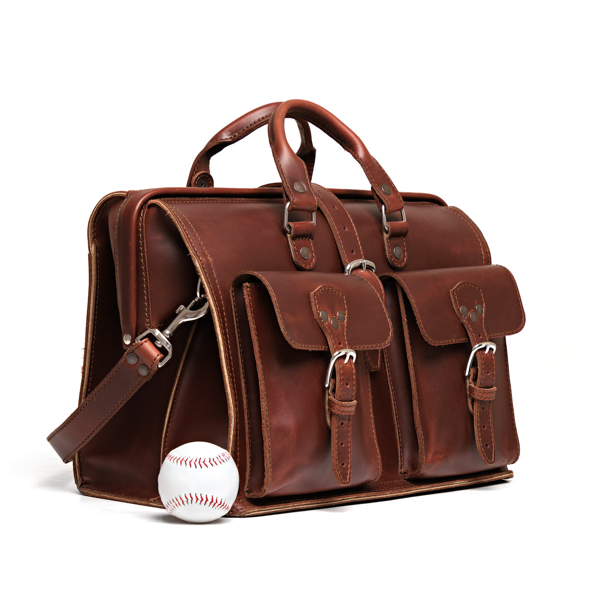 Barrister's Briefcase in Chestnut, angled front view with buckled front pockets, shown beside a baseball for size