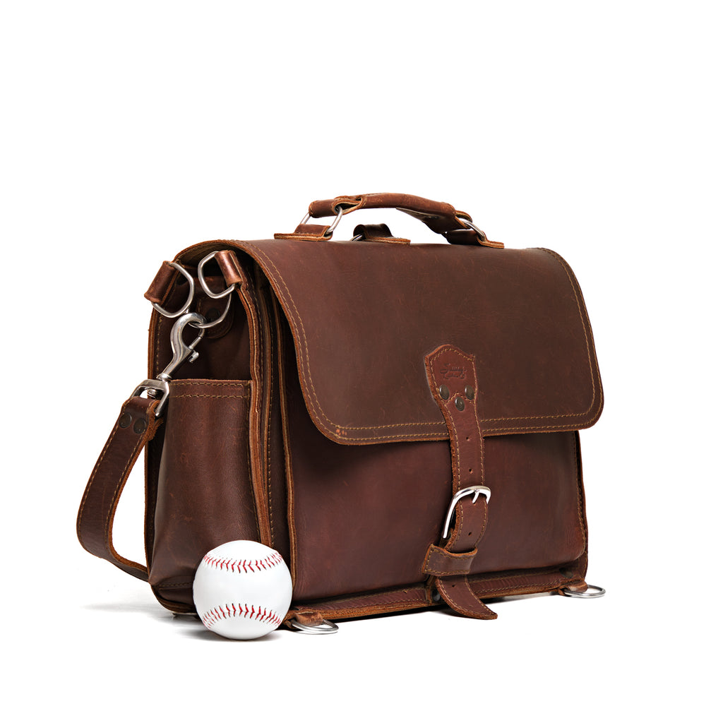 Slim Leather Briefcase in Chestnut, angled front view beside a baseball for size comparison