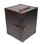 Leather Small Trunk in Dark Coffee Brown, standing upright and closed with top handle, buckled strap and corner guards