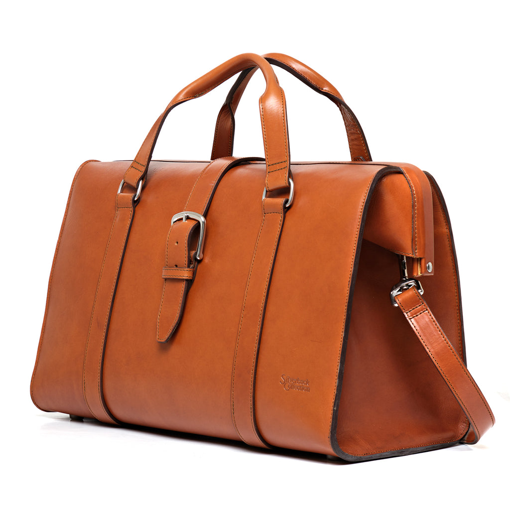Taylor Duffle Bag in English Tan, three-quarter side view with buckle strap and shoulder strap