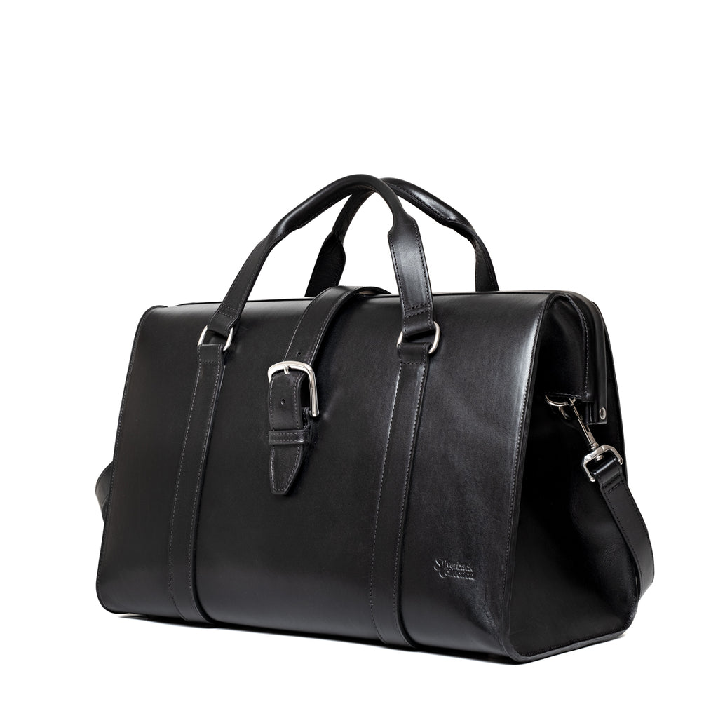 Taylor Duffle Bag in Raven Black, three-quarter side view with buckle strap and clip hardware
