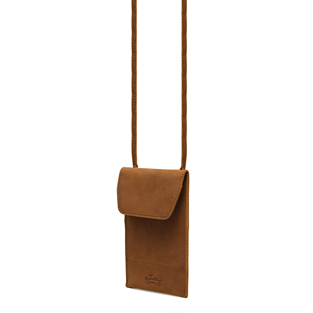 Walker's Pouch in tan, angled front view with flap closure, embossed logo and crossbody strap