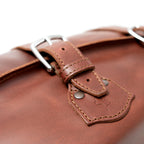 20" Waterbag in Chestnut, close-up of steel buckle, keeper and riveted strap tab