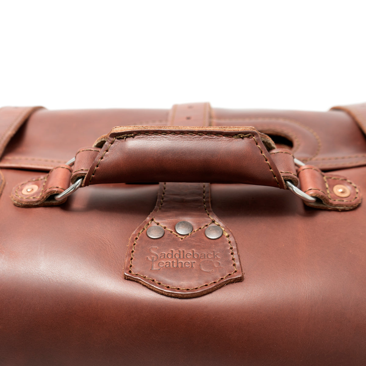 20" Waterbag in Chestnut, close-up of top handle and riveted Saddleback Leather Co. tab