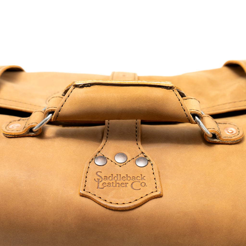20" Waterbag in Tan, close-up of top handle and riveted Saddleback Leather Co. tab