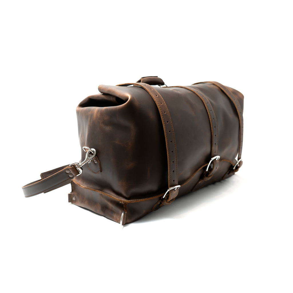 24" Waterbag in dark brown, angled side view showing the end, buckle straps and top handle