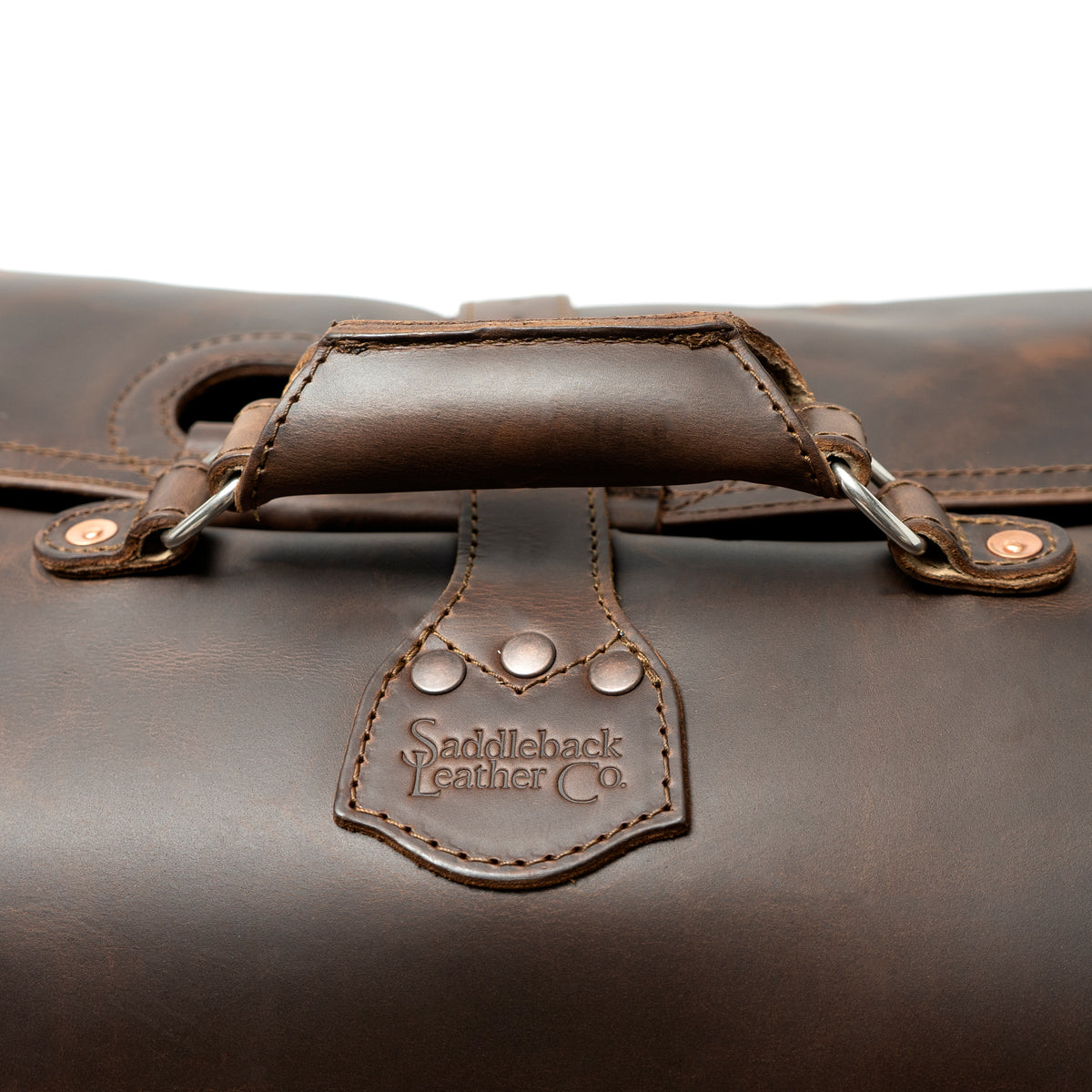 24" Waterbag in dark brown, close-up of the padded top handle and riveted logo tab