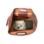 24" Waterbag in reddish brown, top-down view inside packed with blankets, books and a camera
